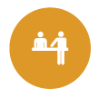 two people at a desk icon